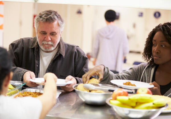 Kitchen Serving Food In Homeless Shelter